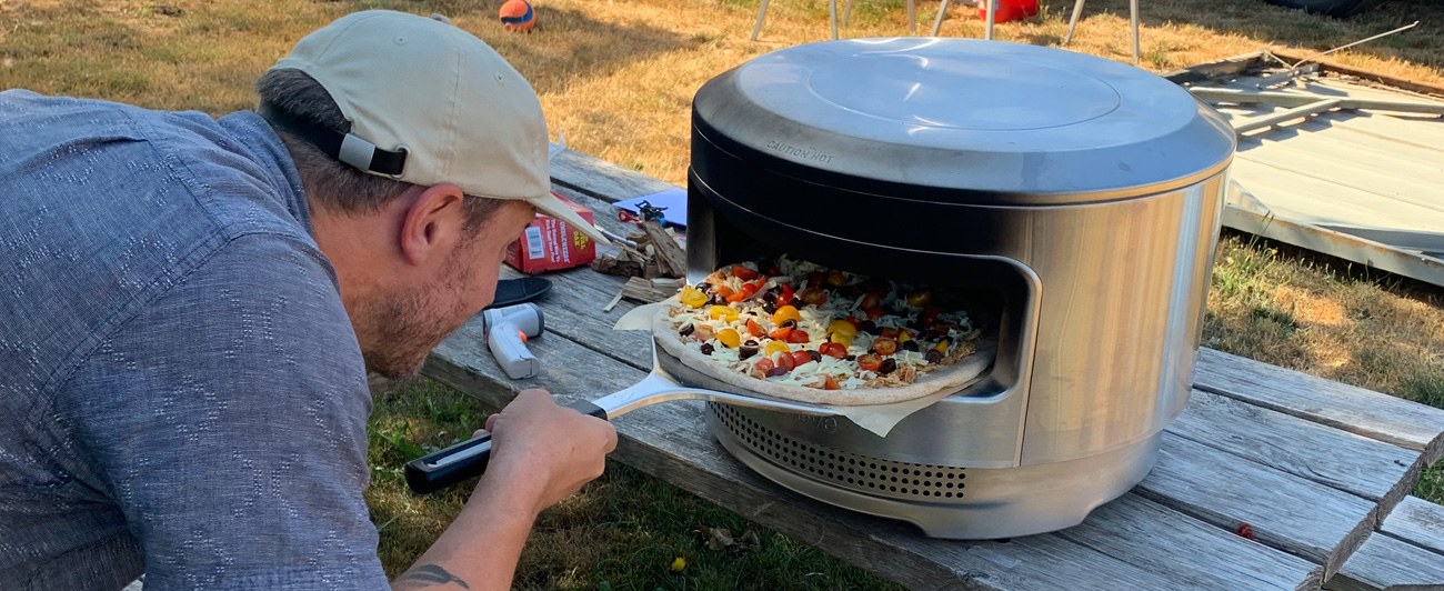 Jason Rolfe placing pizza in Solo Stove.